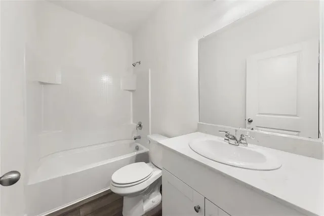 a bathroom with a sink a toilet and a bathtub