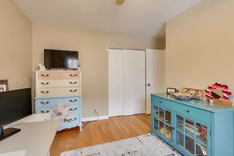 a view of a workspace with furniture and wooden floor