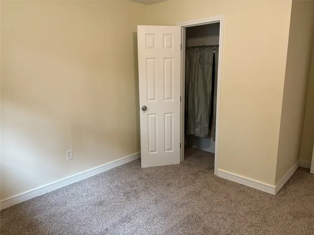 an empty room with closet area