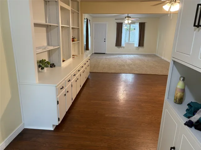 a view of hallway with wooden floor