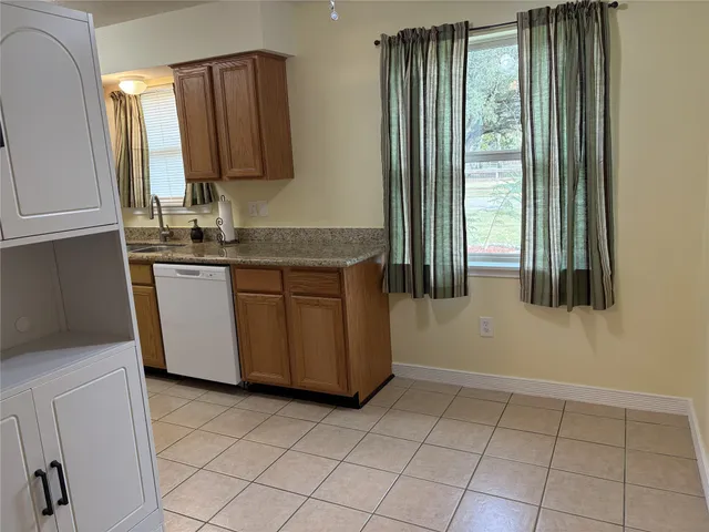 a kitchen with stainless steel appliances a sink a stove and a refrigerator