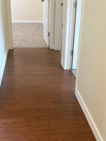 a view of hallway with wooden floor