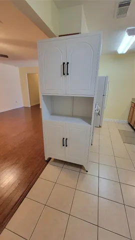 a bathroom with a granite countertop toilet and a sink