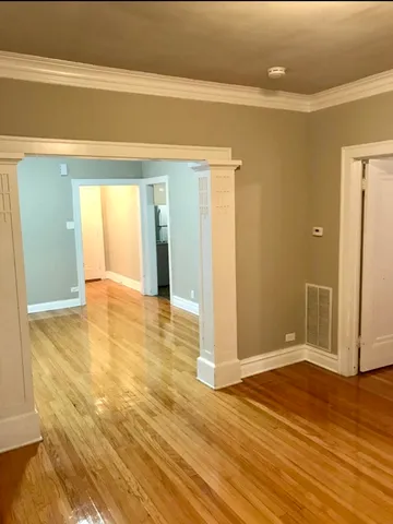 a view of a room with wooden floor