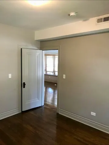 a view of a room with wooden floor and closet