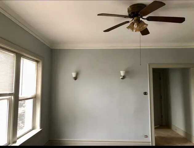 a view of room with a ceiling fan