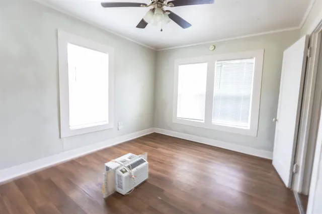 a view of wooden floor and windows in a room