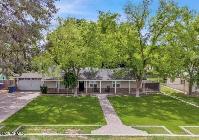 a view of a house with a yard porch and sitting area