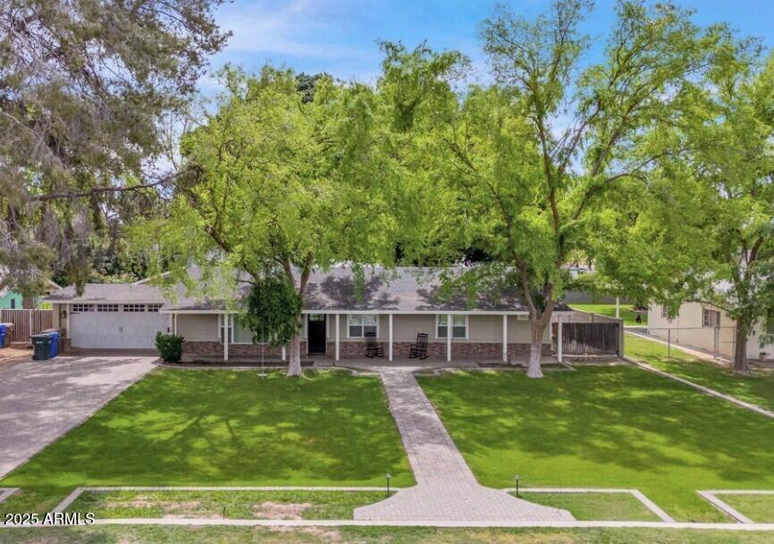 a view of a house with a yard porch and sitting area