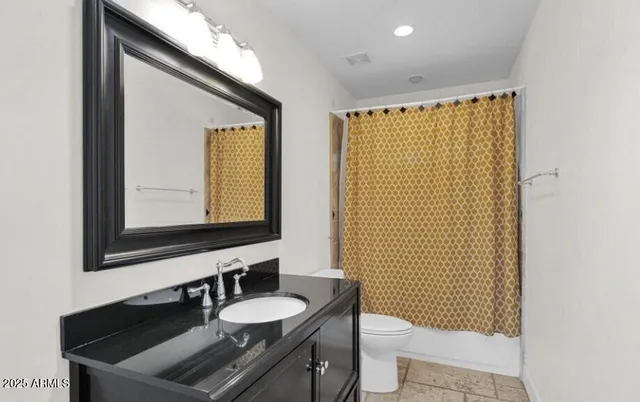 a bathroom with a sink a toilet and mirror