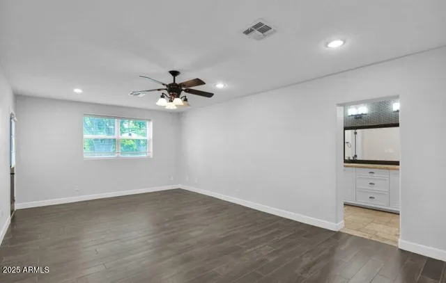 wooden floor in an empty room with a window