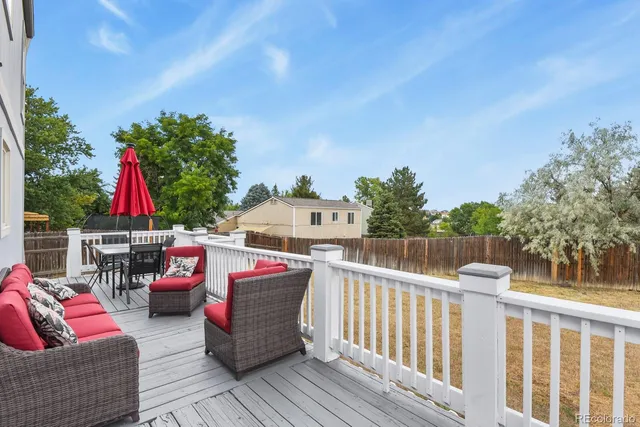 a view of a deck with couches and wooden floor