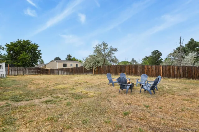 a backyard of a house with table and chairs