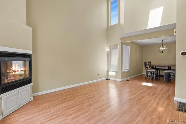 a view of a livingroom with wooden floor and a flat screen tv