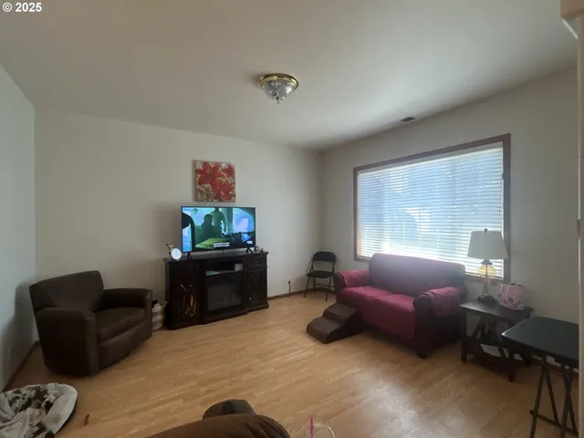 a kitchen with stainless steel appliances kitchen island granite countertop a sink stove and refrigerator