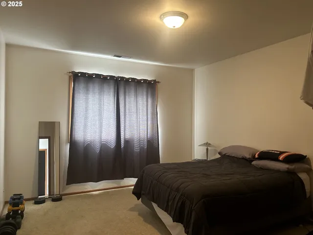 a bedroom with a bed and a mirror