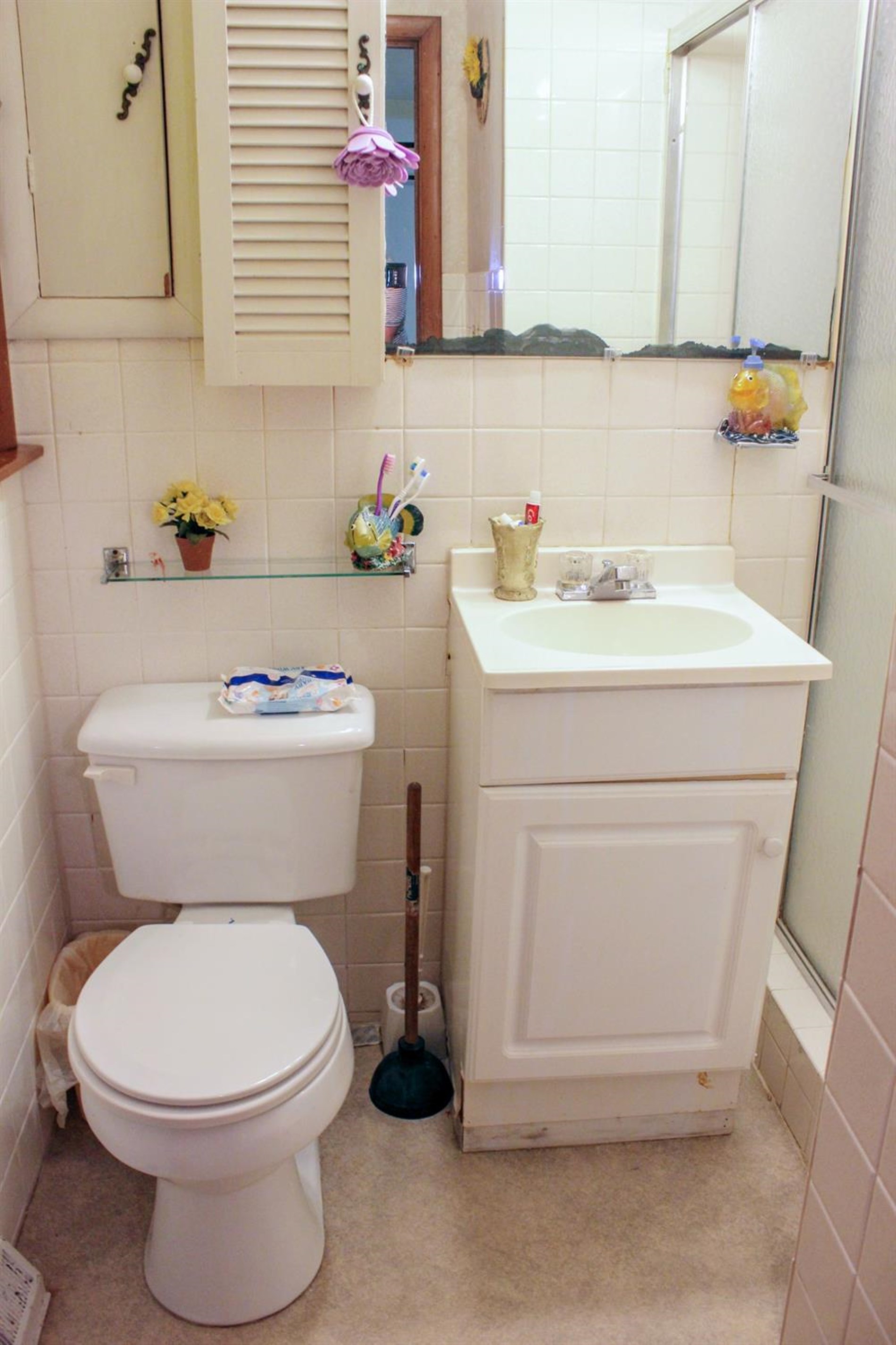 4219 Rutledge Street Gary, IN 46408 - Photo 17 of 27 a white toilet sitting next to a bathroom sink