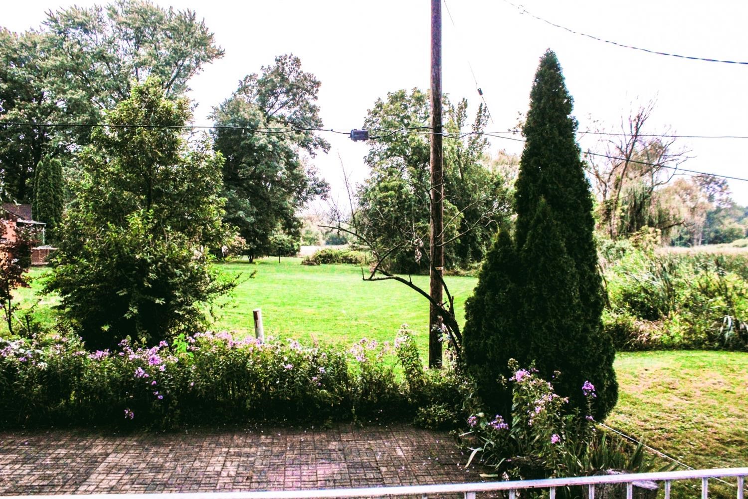 4219 Rutledge Street Gary, IN 46408 - Photo 23 of 27 a view of a garden with a tree