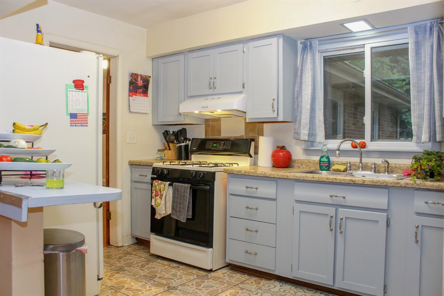 4219 Rutledge Street Gary, IN 46408 - Photo 7 of 27 a kitchen with cabinets appliances and a window