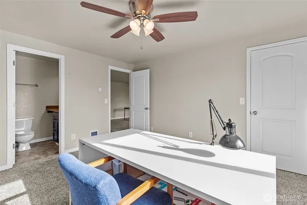 a room with a table chairs and a chandelier