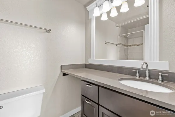 a bathroom with a sink a vanity and a mirror