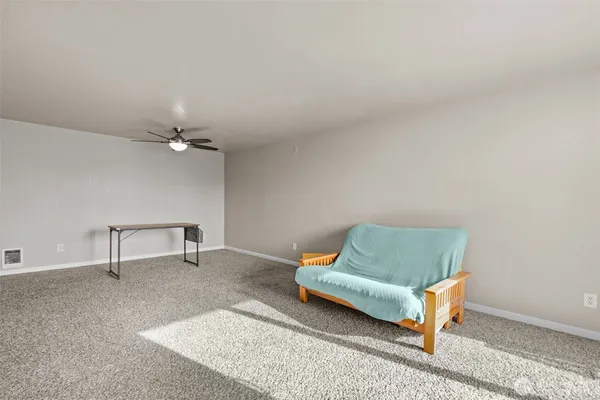 a living room with furniture and a rug