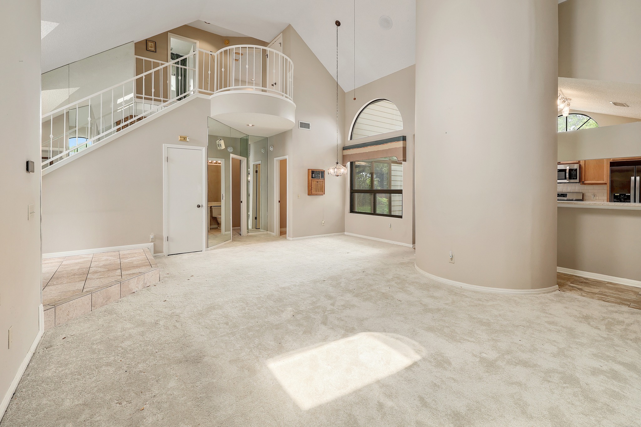 2202 Warfield Way Austin, TX 78728 - Photo 4 of 32 A striking two-story layout features soaring ceilings and an open balcony overlooking the main living area.