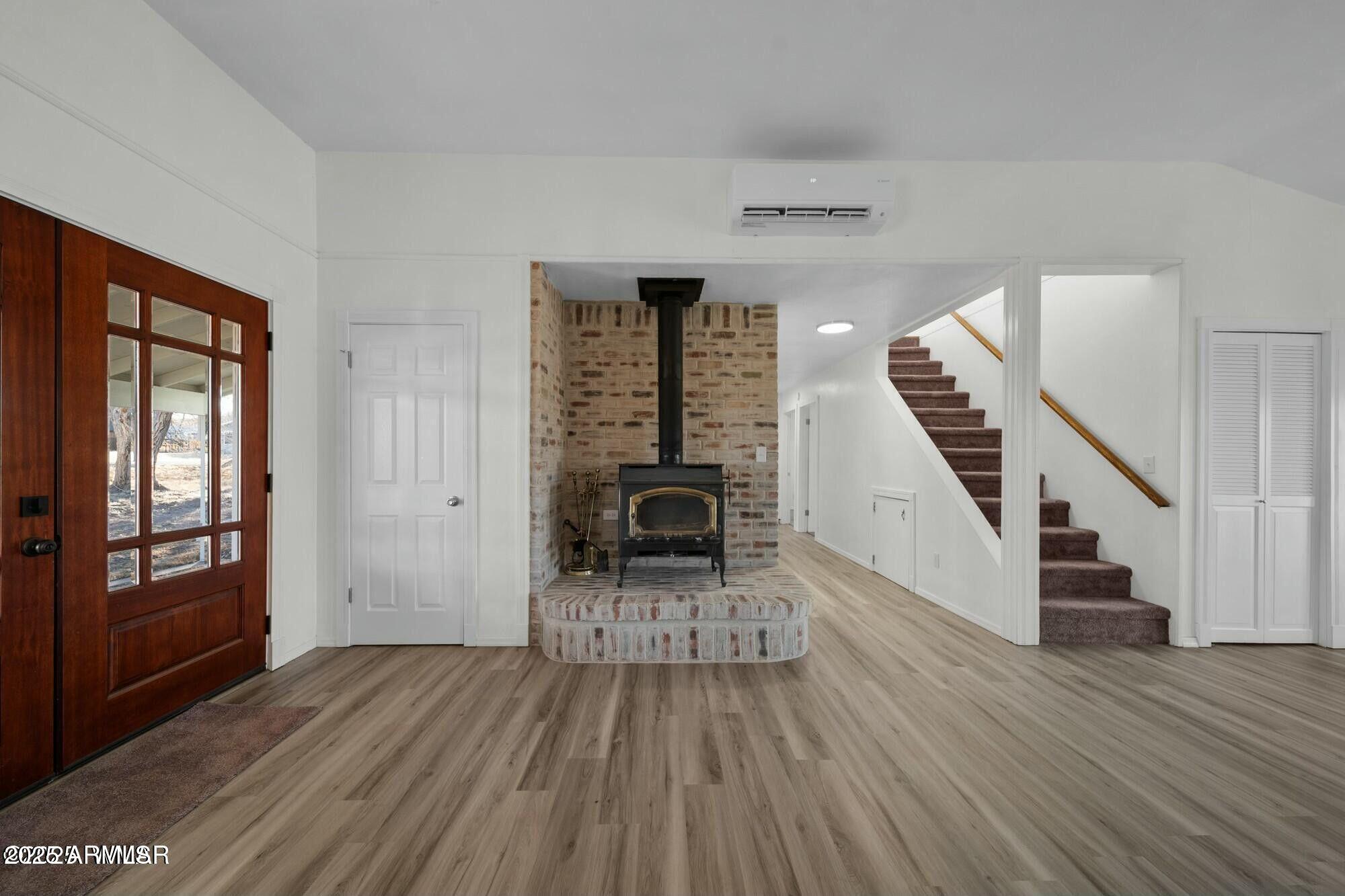723 Tori Circle Springerville, AZ 85938 - Photo 15 of 47 a view of a hallway with wooden floor fireplace and windows