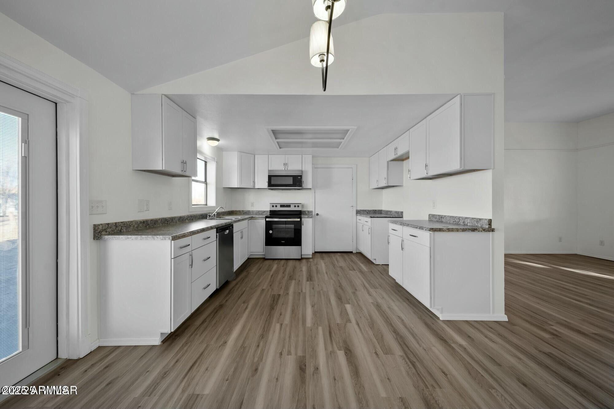 723 Tori Circle Springerville, AZ 85938 - Photo 18 of 47 a kitchen with granite countertop white cabinets and white appliances
