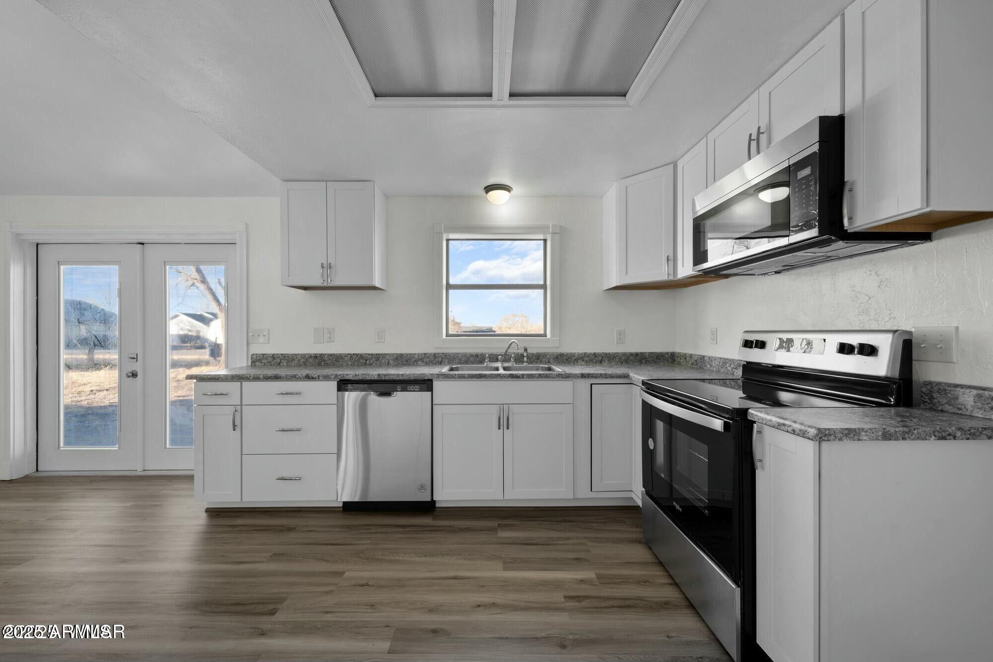 723 Tori Circle Springerville, AZ 85938 - Photo 19 of 47 a kitchen with stainless steel appliances granite countertop a stove a sink and a microwave