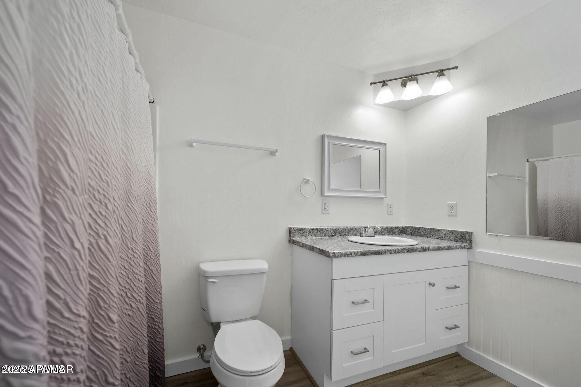 723 Tori Circle Springerville, AZ 85938 - Photo 30 of 47 a bathroom with a granite countertop toilet sink and mirror