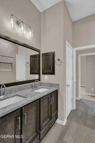 a bathroom with double sink and a mirror