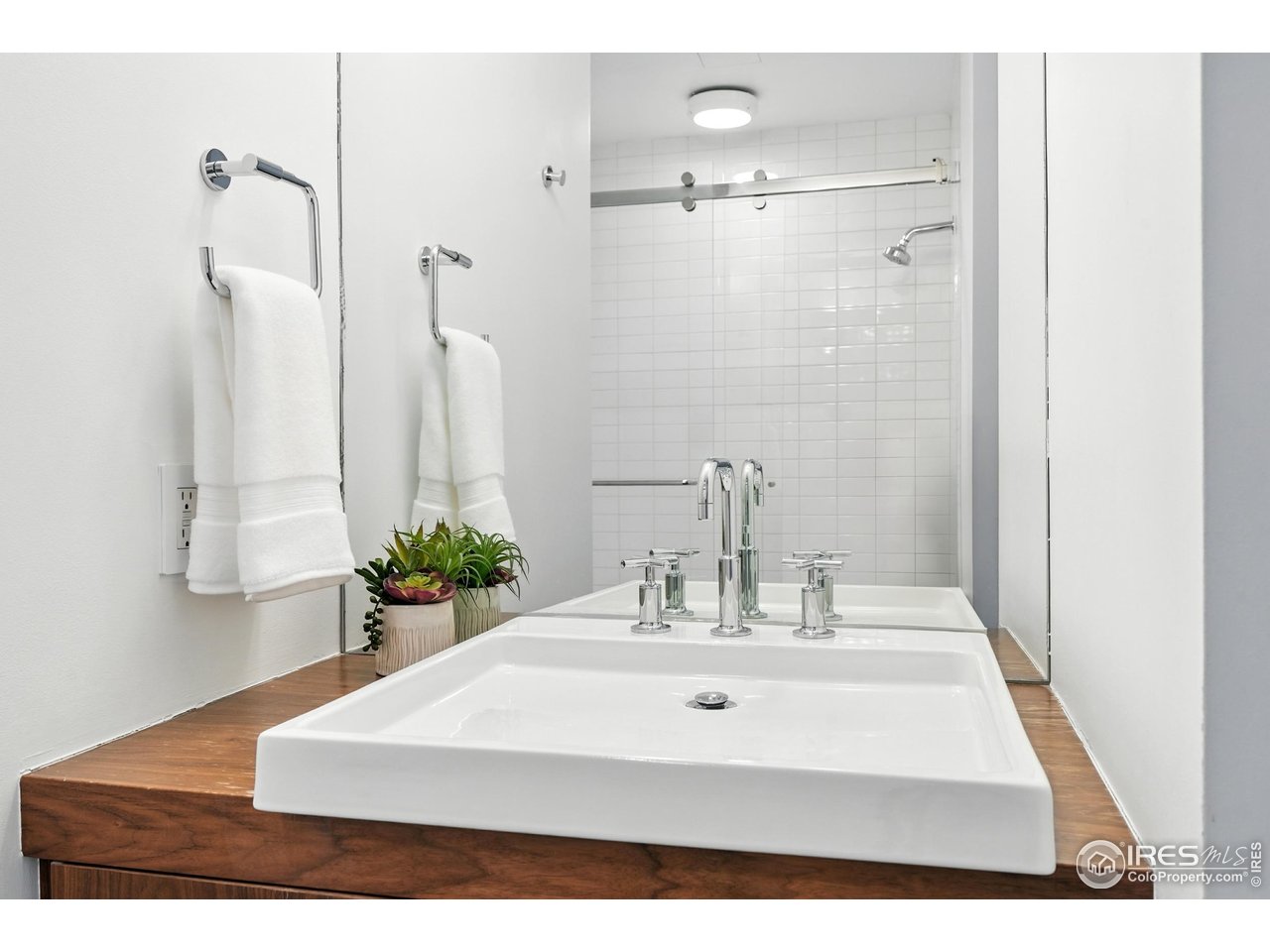 1360 Walnut Street, Unit 401 Boulder, CO 80302 - Photo 15 of 18 a bathroom with a sink a mirror and shower