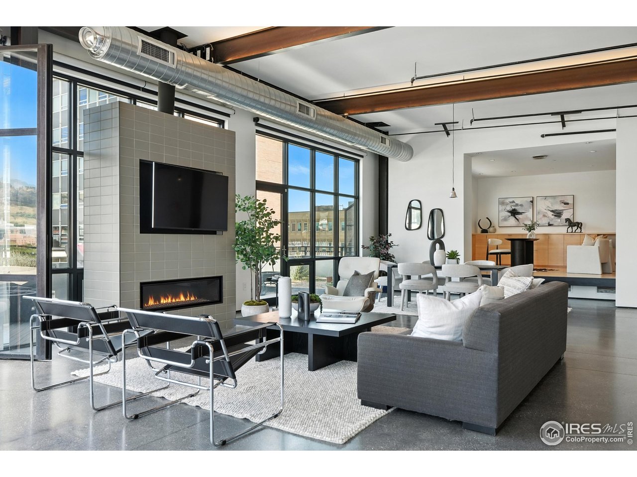 1360 Walnut Street, Unit 401 Boulder, CO 80302 - Photo 3 of 18 a living room with furniture and a flat screen tv