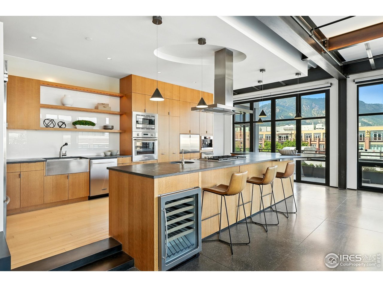 1360 Walnut Street, Unit 401 Boulder, CO 80302 - Photo 4 of 18 a dining hall with stainless steel appliances kitchen island granite countertop a stove and a view of living room
