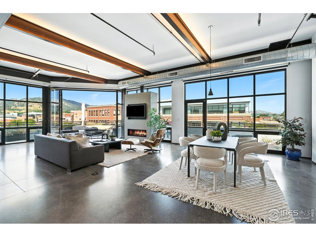 1360 Walnut Street, Unit 401 Boulder, CO 80302 - Photo 6 of 18 a living room with furniture a flat screen tv and floor to ceiling window