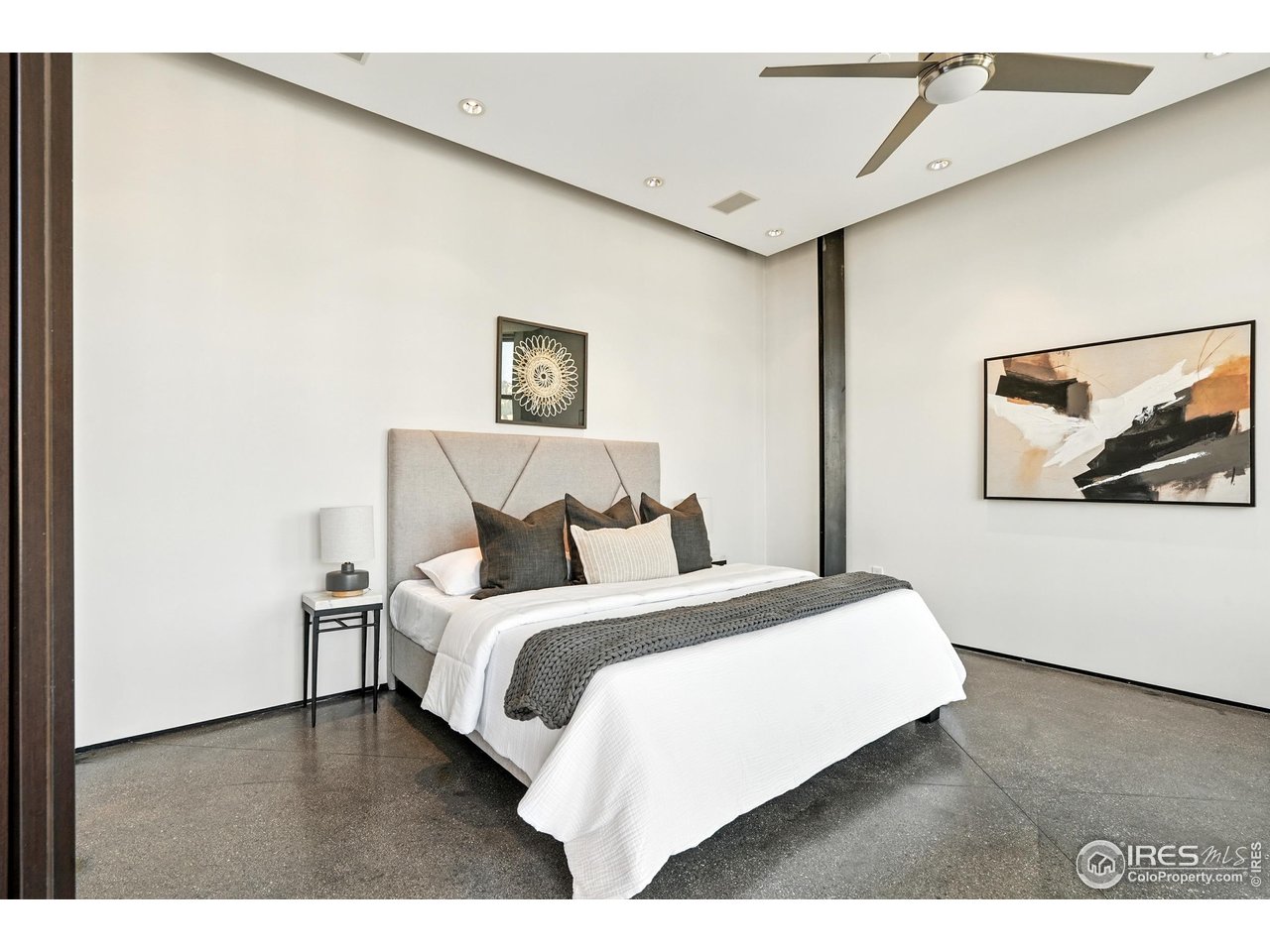 1360 Walnut Street, Unit 401 Boulder, CO 80302 - Photo 9 of 18 a bedroom with a bed and a painting on the wall