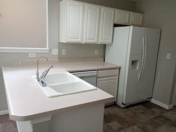 a kitchen with stainless steel appliances a refrigerator and a sink