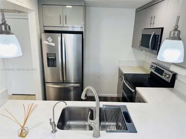 a kitchen with a refrigerator and a sink