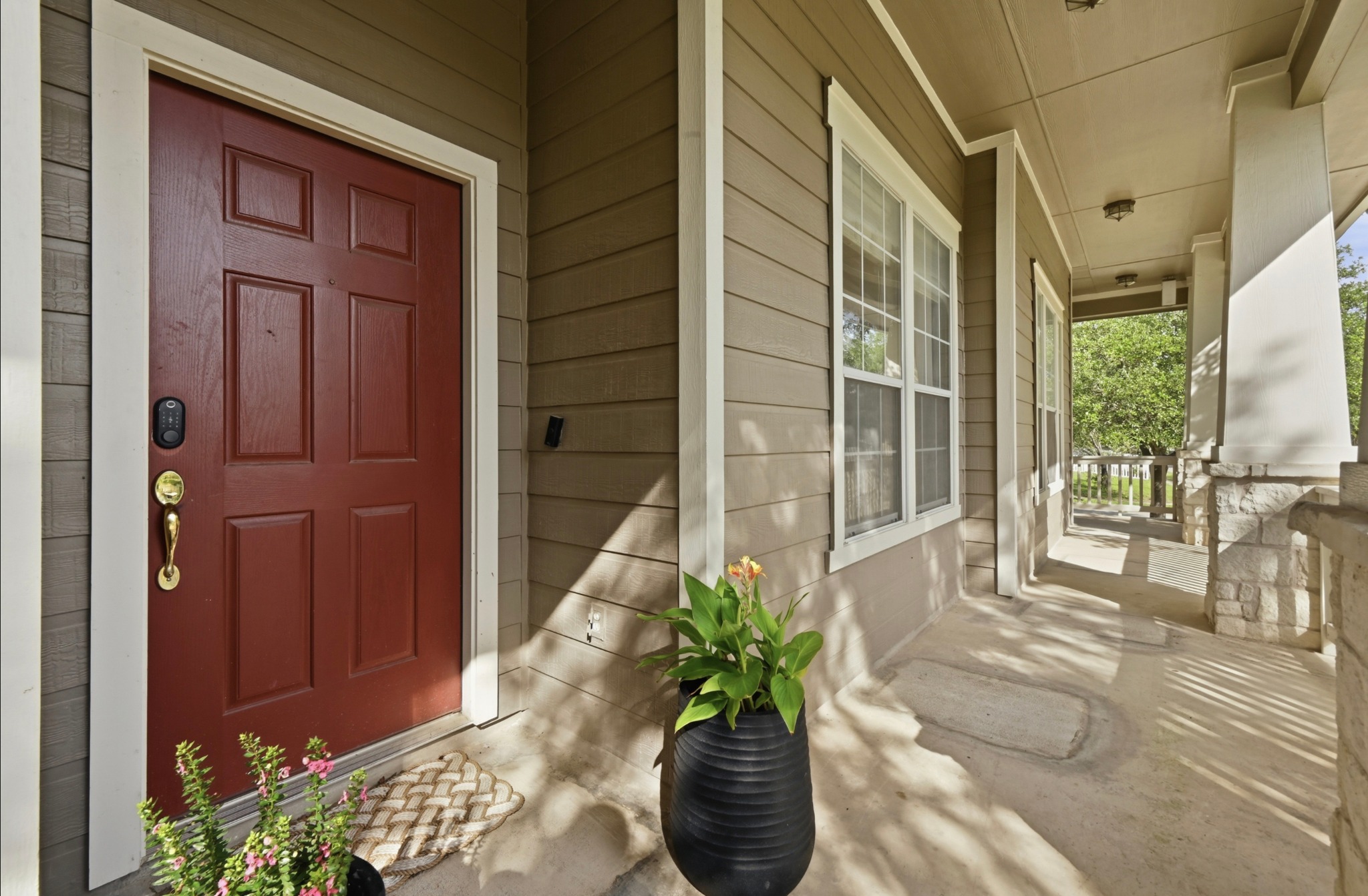 5888 Fergus Kyle, TX 78640 - Photo 2 of 40 A welcoming front porch features sturdy stone-clad columns and a classic paneled entry door.