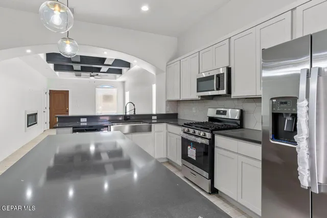 a kitchen with stainless steel appliances a stove sink and microwave