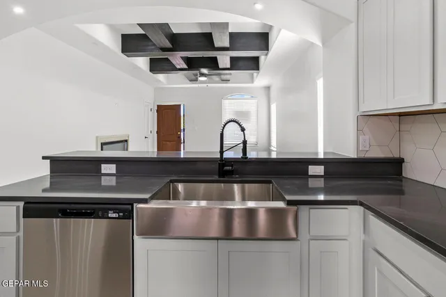 a kitchen with stainless steel appliances granite countertop a sink and a microwave