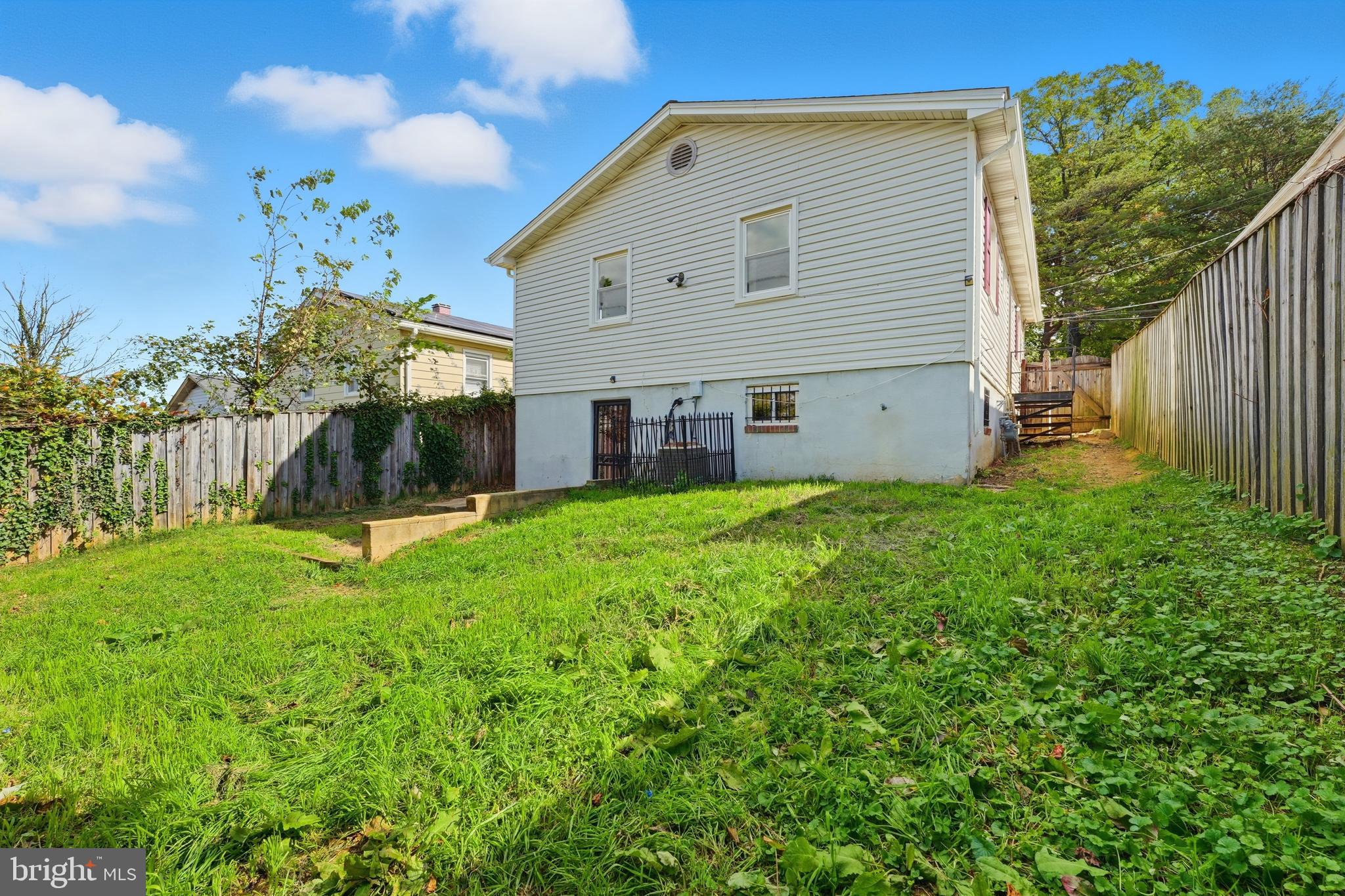 1213 Quo Avenue Capitol Heights, MD 20743 - Photo 15 of 15 a view of a house with backyard and a tree