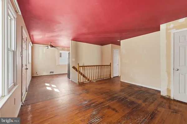 a view of a livingroom with wooden floor and window