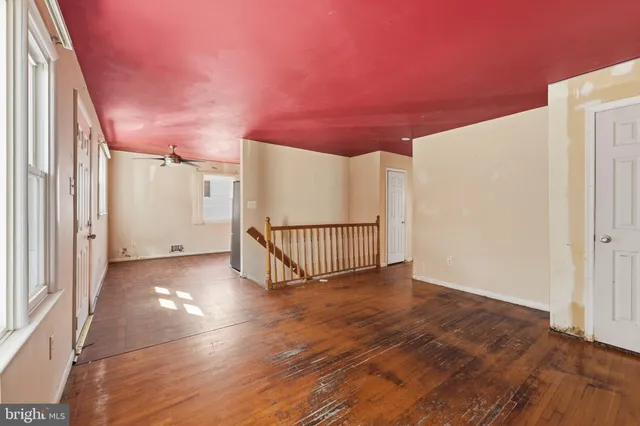 a view of a livingroom with wooden floor and window