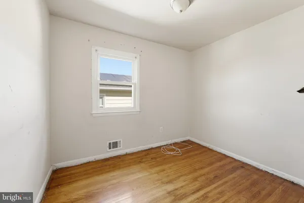 a view of a room with wooden floor and natural light