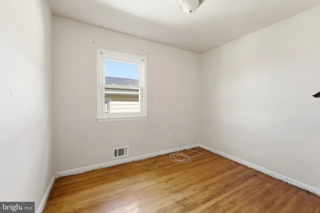 a view of a room with wooden floor and natural light
