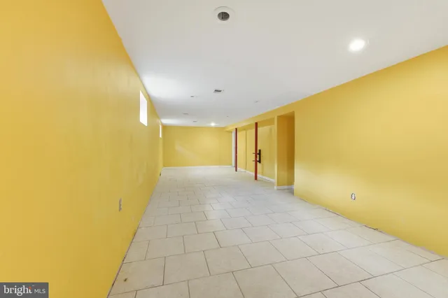 a view of livingroom with painted wall and a large window