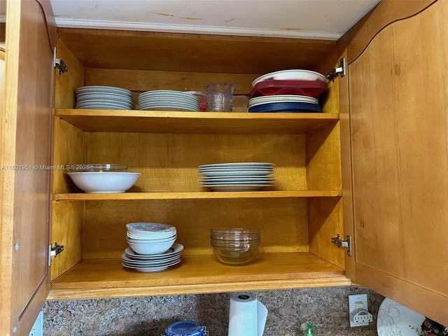 a hallway with dining table and chairs