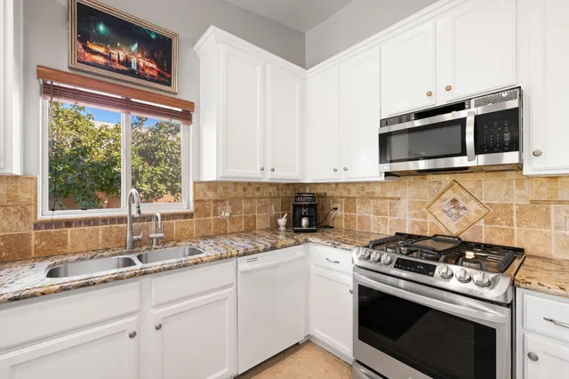 a spacious bedroom with a bed and a flat screen tv